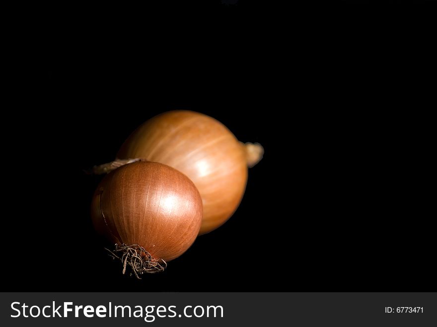 Onions set in a dark background which is used in many foods. Onions set in a dark background which is used in many foods.