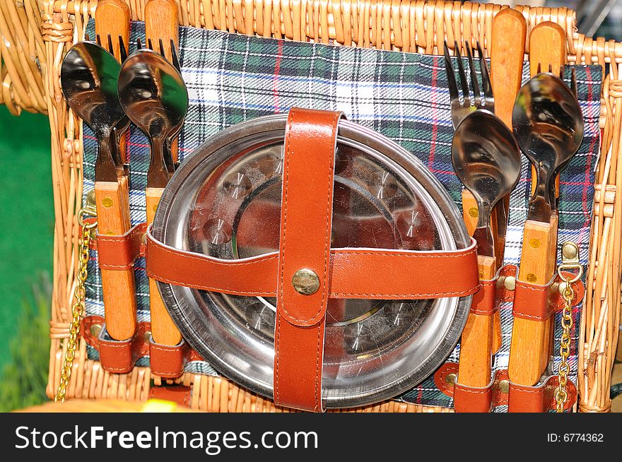 Set of dishware in the basket for a picnic