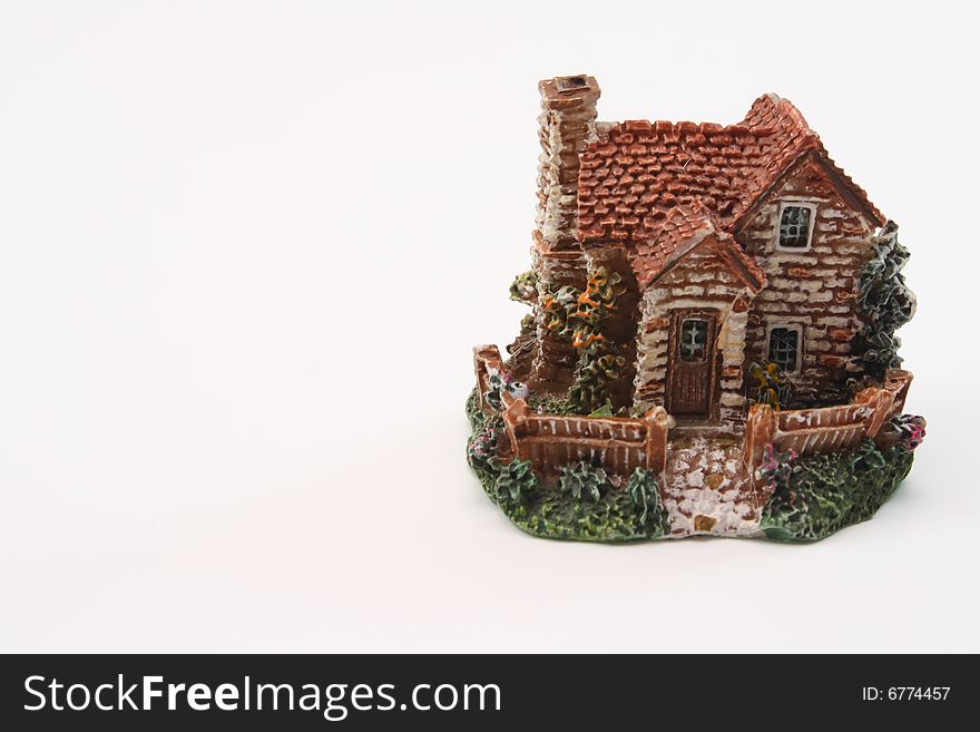 Toy village house stands on a white background