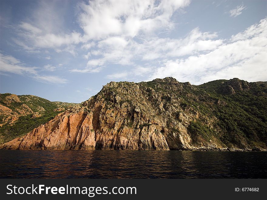 Rocky Waterline. Mediterranean Sea and Corsican Mountain Rocks. Coastline outside Porto, Corse-Du-Sud, Corsica, France