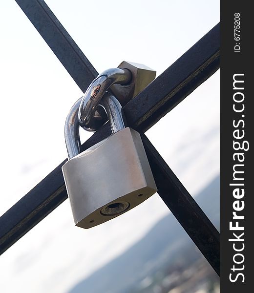 Two steel padlocks locked together. Two steel padlocks locked together