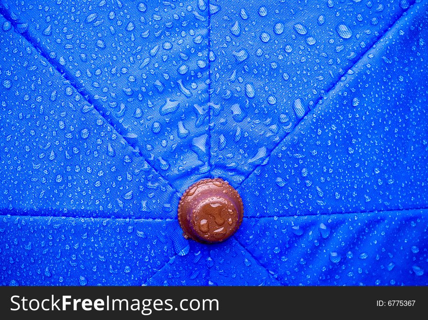 A closeup of a wet blue unmbrella. A closeup of a wet blue unmbrella