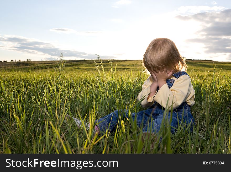 Little girl sit in grass