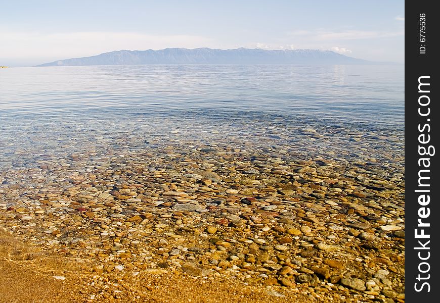 Clear water of Baikal. Summer landscape at the Baikal lake in Siberia. Clear water of Baikal. Summer landscape at the Baikal lake in Siberia