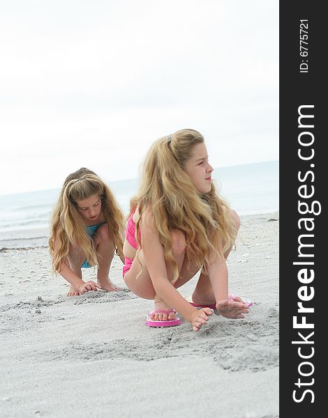 Sisters in the sand vertical