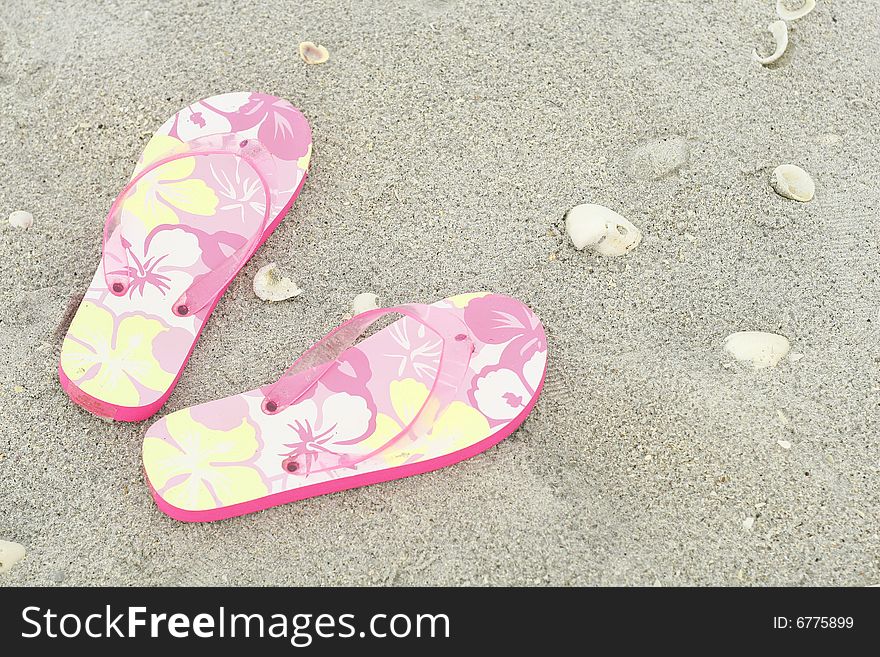 Shot of flip flops in the sand