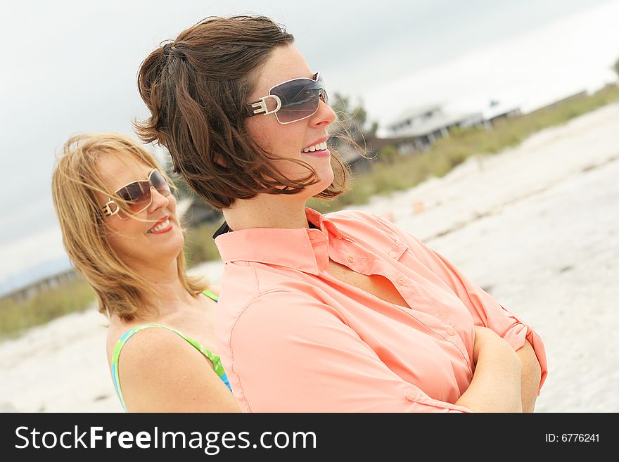 Beautiful women at the beach angle - side