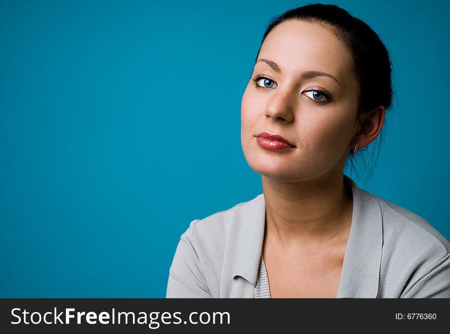 The woman on a dark blue background close up. The woman on a dark blue background close up