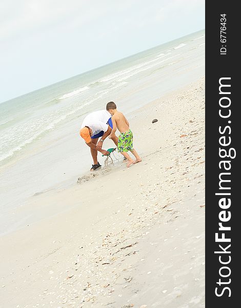 Shot of a father & son looking for shells