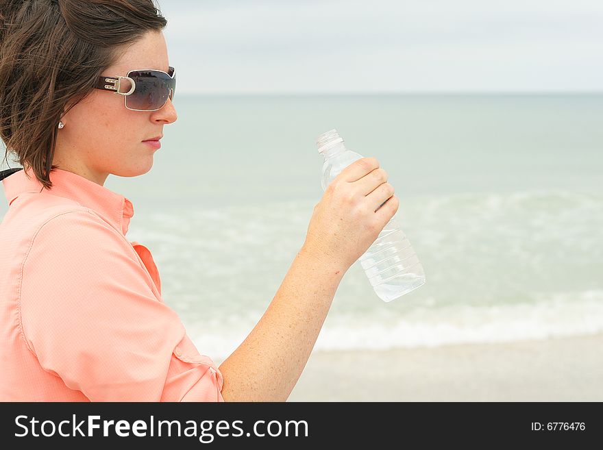 Shot of a brunette with bottled water