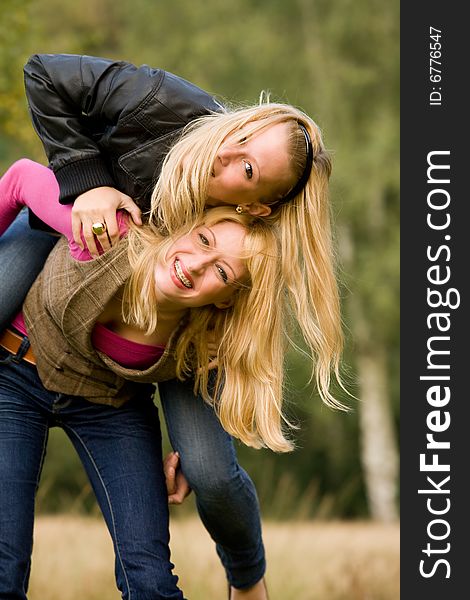 Two sisters in a park having fun. Two sisters in a park having fun