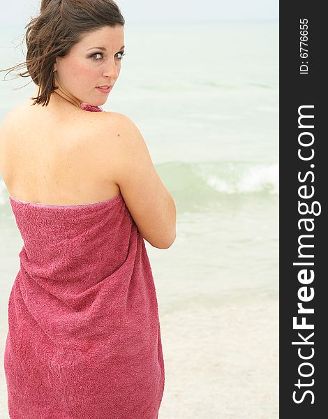 Shot of a brunette covering herself with a towel