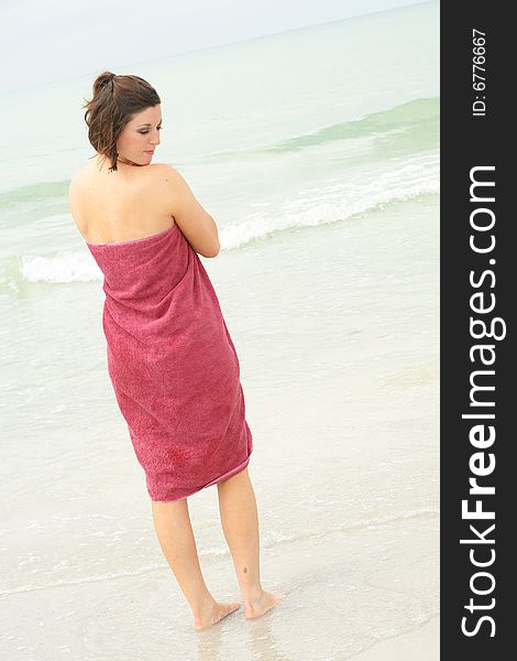 Shot of a brunette covering herself with a towel vertical