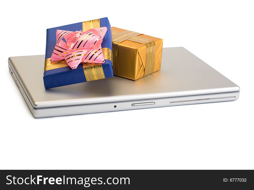 A photo of some gift boxes over laptop. A photo of some gift boxes over laptop