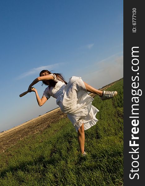 Girl with baseball bat in the field. Girl with baseball bat in the field