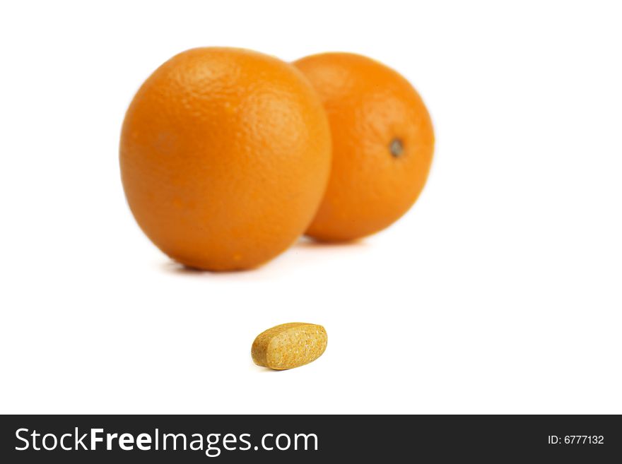 A photo of orange and pills. A photo of orange and pills