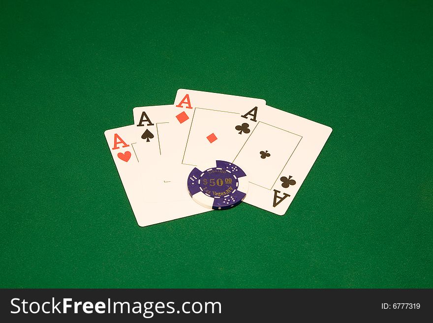 Four aces on the green table in casino with chips. Four aces on the green table in casino with chips