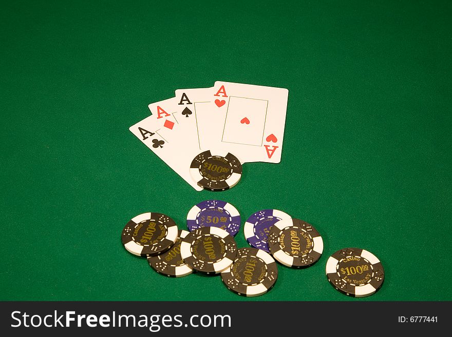 Chips with four aces on the green table in casino. Chips with four aces on the green table in casino