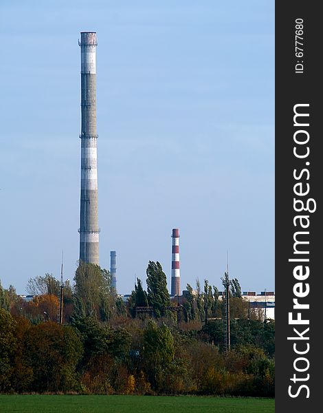 Factory with chimneys in an environment of trees. Factory with chimneys in an environment of trees