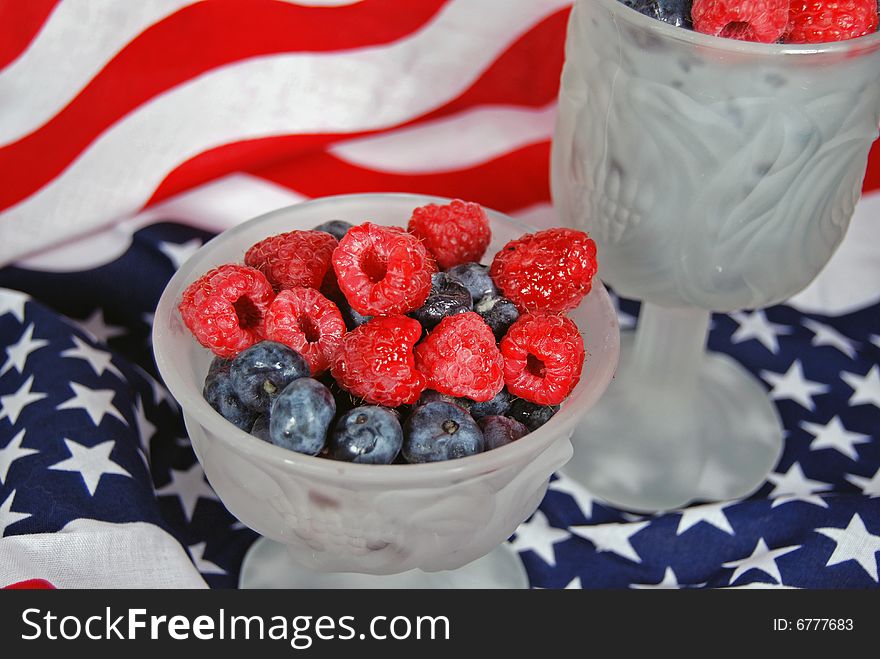 Blueberries and raspberries on an American flag. Blueberries and raspberries on an American flag.