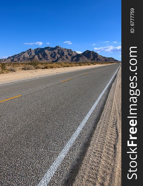 Old asphalt road in the California with blue sky. Old asphalt road in the California with blue sky