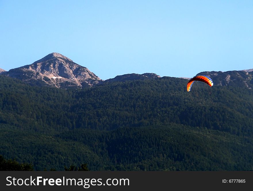 Kite in the sky with mountain in background. Kite in the sky with mountain in background