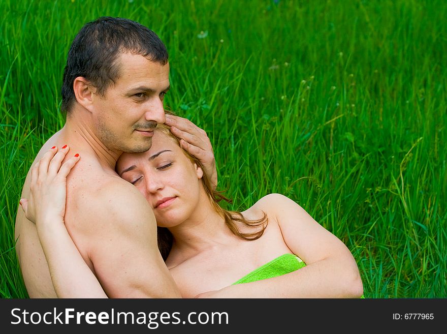 Young couple resting in a grass field. Young couple resting in a grass field
