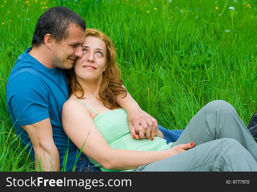 Young loving couple relaxing in nature. Young loving couple relaxing in nature