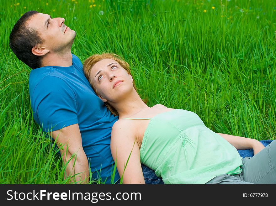Young Couple Sitting In Grass