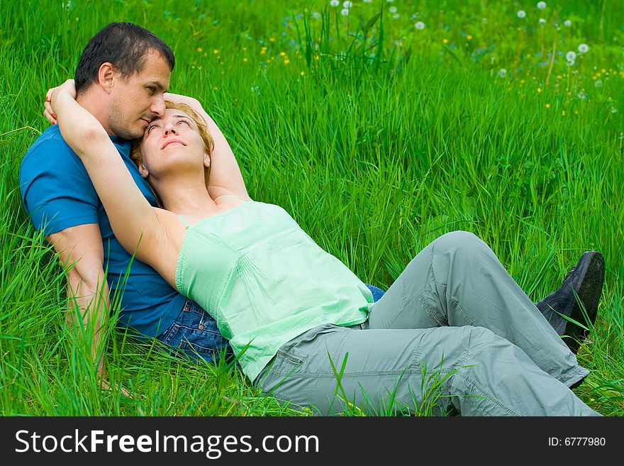 Young couple sitting in grass