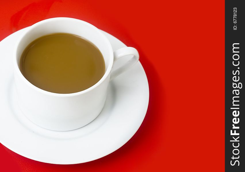 Classic cup and saucer set against red background