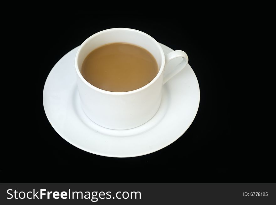 Classic cup and saucer set against black background