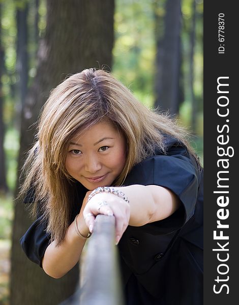 Beautiful asian woman on the bridge fence