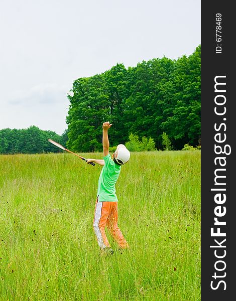 Cute kid playing badminton outdoors