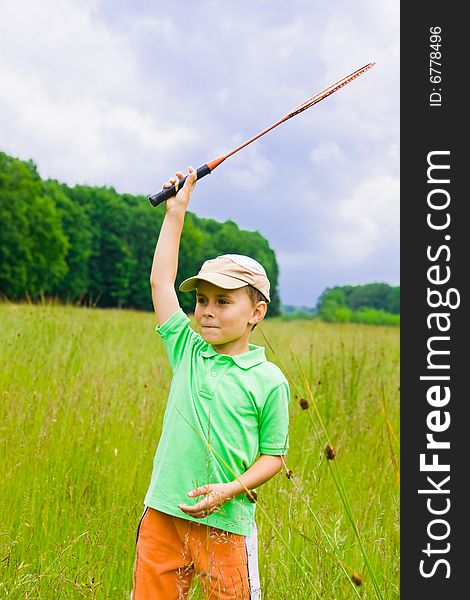 Cute kid playing badminton outdoors