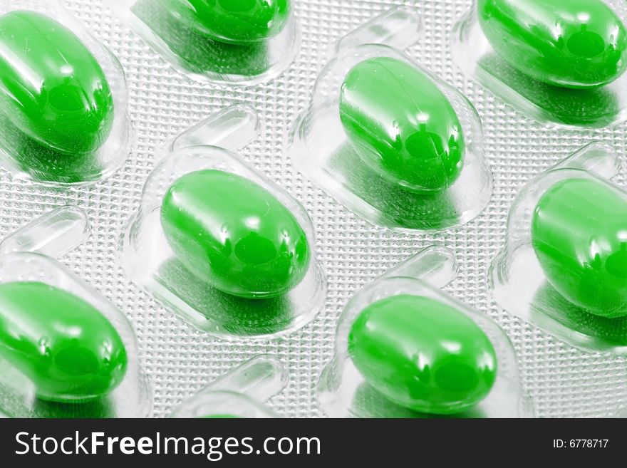 Green oval medical pills in their packages. Green oval medical pills in their packages