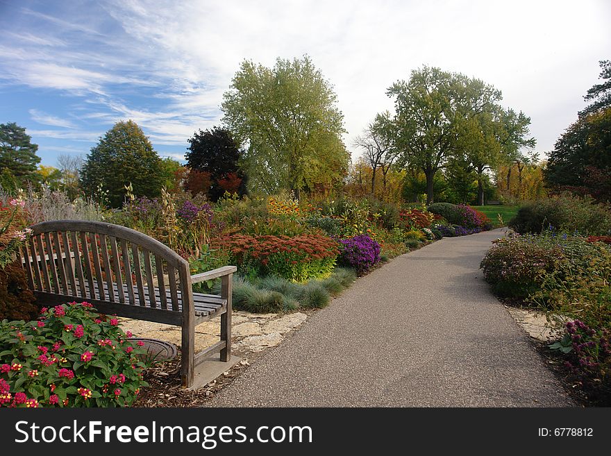 A picture of a trail leading through beautiful garden. A picture of a trail leading through beautiful garden