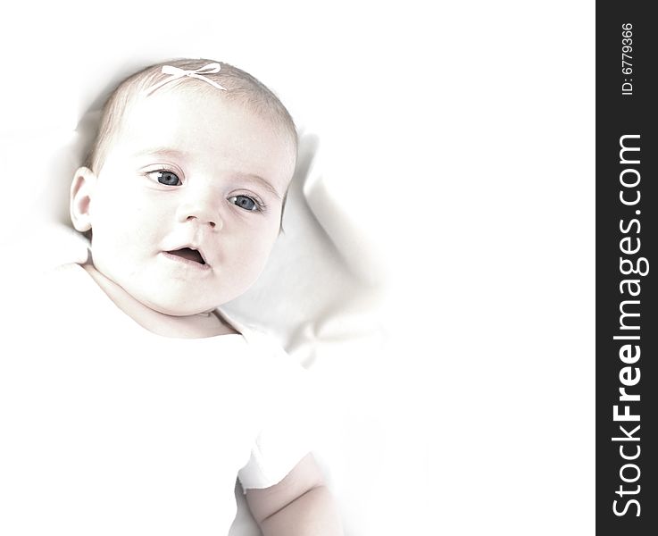 New born baby girl with bow lying on a white blanket. New born baby girl with bow lying on a white blanket