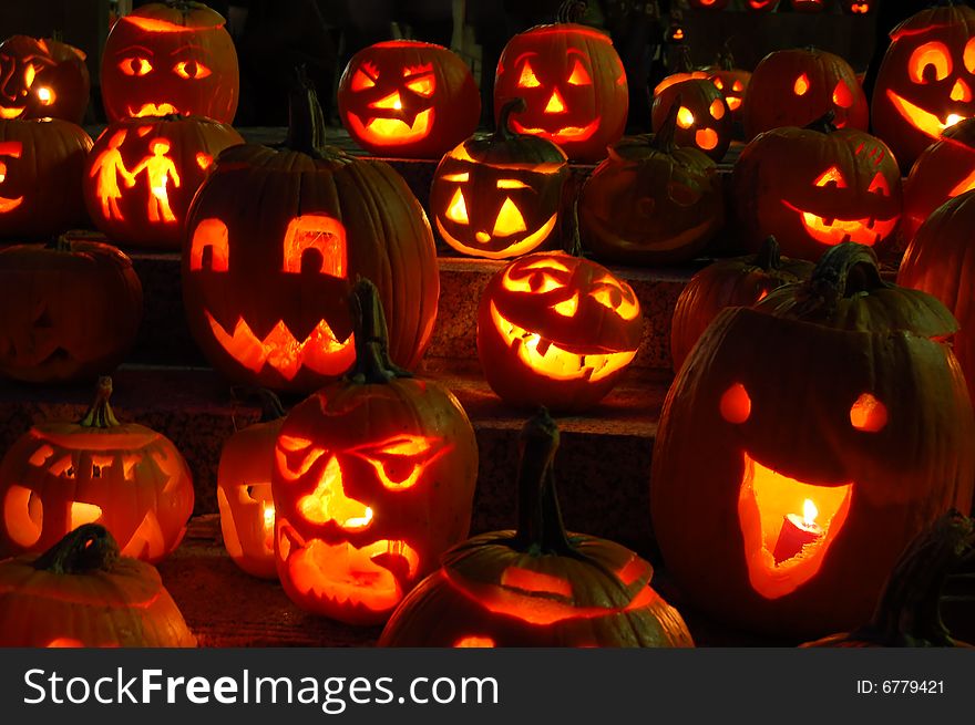 Glowing pumpkins at night at a pumpkin festival. Lit by candles. Glowing pumpkins at night at a pumpkin festival. Lit by candles.