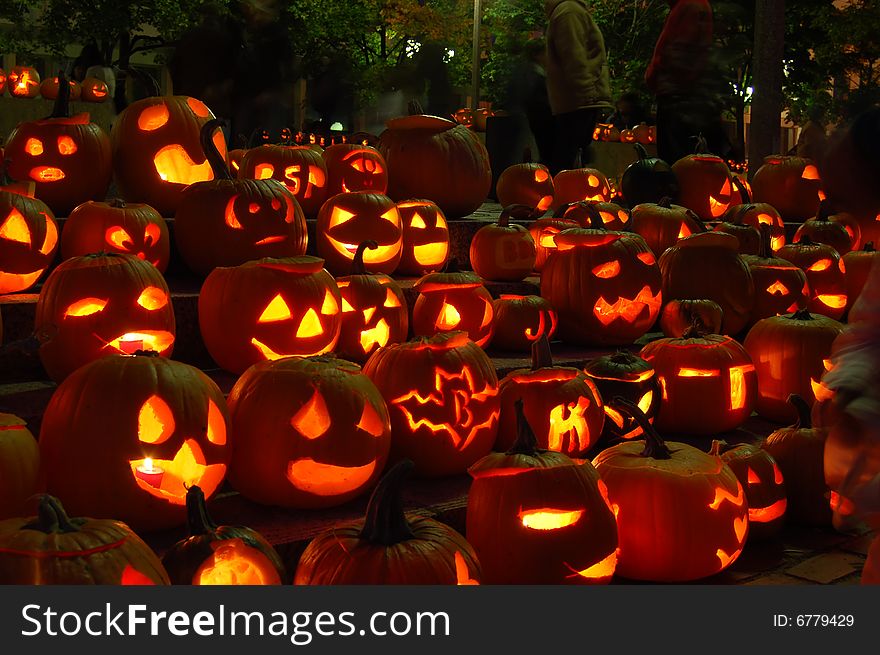 Glowing pumpkins at night at a pumpkin festival. Lit by candles. Glowing pumpkins at night at a pumpkin festival. Lit by candles.