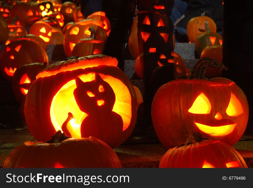 Glowing pumpkins at night at a pumpkin festival. Lit by candles. Glowing pumpkins at night at a pumpkin festival. Lit by candles.