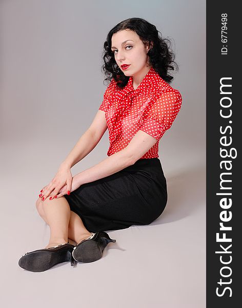 Retro fifties pin-up attractive girl in red polka-dot blouse on colorful background - pin-up concept. Retro fifties pin-up attractive girl in red polka-dot blouse on colorful background - pin-up concept