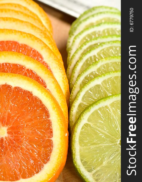 Orange and Lime Slices arranged on a cutting board with a knife