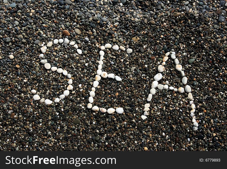 Sea word on the wet pebbles