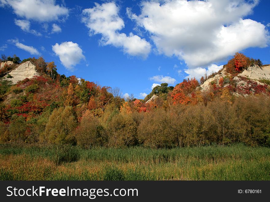 Mountains covered colored autumn trees. Mountains covered colored autumn trees