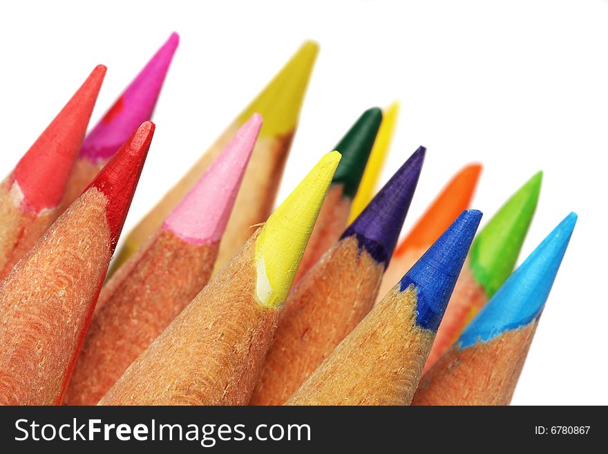 Close up of color pencils with different color over white background.