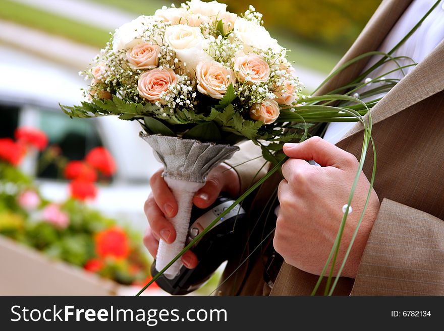 Bridegroom is holding flowers in his hand. Bridegroom is holding flowers in his hand