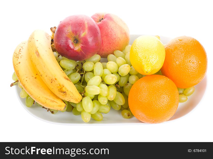 Close-up fruits on plate, isolated on white