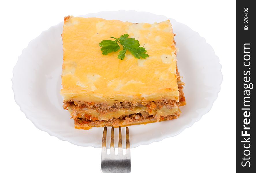Lasagne on plate with fork, isolated on white