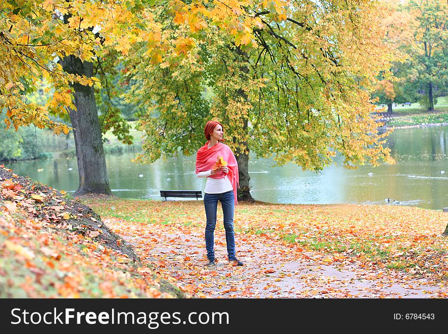 Young girl walking in autumn park. Young girl walking in autumn park